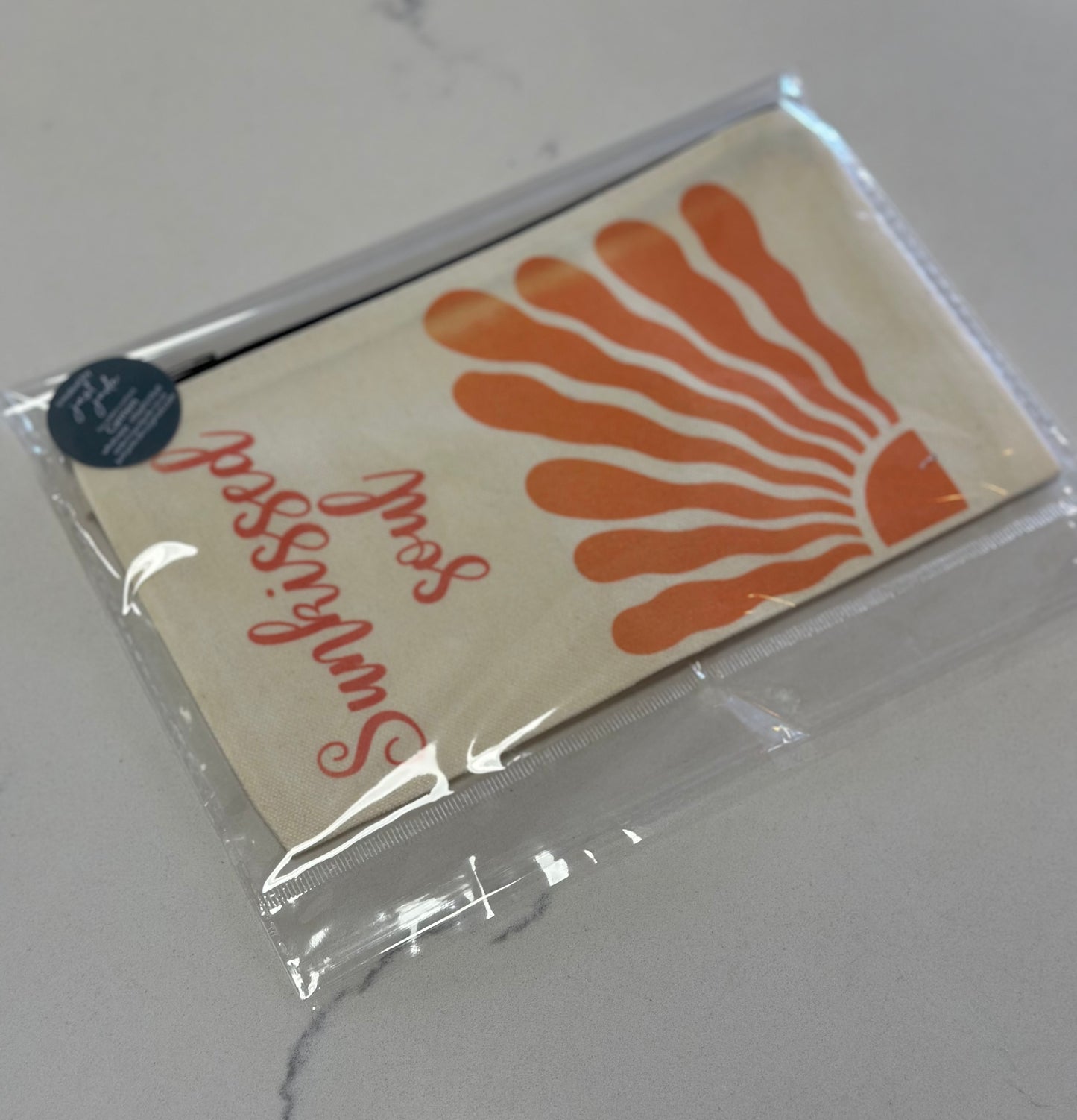Packaged product with orange coral design and red text on a white background