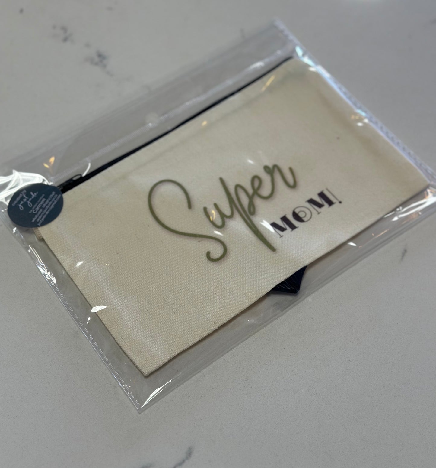 Packaged card with 'Super Mom!' text on a white surface